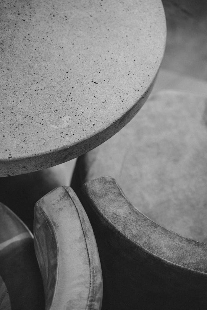 The Art of Drawing Readers In: Your attractive post title goes here Black and white photo of a modern interior with round tables and chairs.
